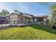 Charming home featuring manicured lawn, brick accents, black fence, and attached two-car garage at 10909 W 65Th Way, Arvada, CO 80004