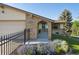 Charming home featuring an arched brick entryway, garden bed, two-car garage, and a walkway at 10909 W 65Th Way, Arvada, CO 80004