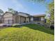 Charming home with a well-manicured lawn and colorful flower garden at 10909 W 65Th Way, Arvada, CO 80004