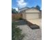 Well-maintained front yard with garden beds and a two-car garage at 10909 W 65Th Way, Arvada, CO 80004