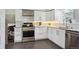 Modern kitchen featuring white cabinets, stainless steel appliances, granite countertops, and subway tile backsplash at 10909 W 65Th Way, Arvada, CO 80004