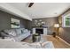 Living room boasts a sleek fireplace, comfortable seating, and ample natural light at 10909 W 65Th Way, Arvada, CO 80004