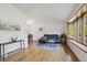 Bright living room showcasing hardwood floors, a bay window, and neutral decor at 10909 W 65Th Way, Arvada, CO 80004