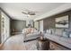 Living room boasts comfortable seating, a ceiling fan, and ample space at 10909 W 65Th Way, Arvada, CO 80004
