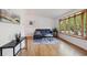 Bright living room with hardwood floors, bay window, modern decor, and lots of natural light at 10909 W 65Th Way, Arvada, CO 80004