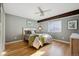 Cozy bedroom with hardwood floors, neutral walls, a ceiling fan, and natural light at 10909 W 65Th Way, Arvada, CO 80004