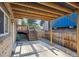 Covered patio area with wooden stairs to access the upper deck and fenced backyard at 10909 W 65Th Way, Arvada, CO 80004