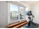 Balcony access via sliding doors, adjacent to an exercise area with city views at 1560 Blake St # 810, Denver, CO 80202