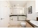 Bright bathroom showcasing a shower-tub combo with glass doors, tiled walls, and modern fixtures at 1560 Blake St # 810, Denver, CO 80202