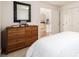 Bedroom featuring a wooden dresser with a large mirror, a bed, and a glimpse into the kitchen at 1560 Blake St # 810, Denver, CO 80202