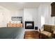 Primary bedroom featuring a fireplace, hardwood floors, and a comfortable seating area at 1560 Blake St # 810, Denver, CO 80202