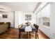 Dining room featuring hardwood floors, modern decor, and views overlooking the neighborhood at 1560 Blake St # 810, Denver, CO 80202