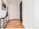 Hallway with hardwood flooring, contemporary decor, and access to various rooms at 1560 Blake St # 810, Denver, CO 80202