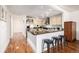 Kitchen with granite counters, stainless appliances, a breakfast bar, and hardwood floors at 1560 Blake St # 810, Denver, CO 80202