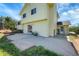Backyard concrete patio, with sliding glass door, and view of the fenced yard and mature trees at 2882 Gentry Ct, Watkins, CO 80137