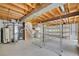 Unfinished basement with utilities and shelving awaiting personalization and ample storage at 2882 Gentry Ct, Watkins, CO 80137