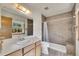 Well-lit bathroom with a granite-style shower, modern vanity, and an updated toilet for comfort at 2882 Gentry Ct, Watkins, CO 80137