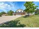 Charming two-story home featuring a well-maintained lawn, spacious driveway, and attached two-car garage at 2882 Gentry Ct, Watkins, CO 80137