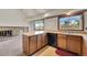 Functional kitchen with a central island, wooden cabinetry, and modern appliances for efficient cooking at 2882 Gentry Ct, Watkins, CO 80137