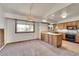 Eat-in kitchen with wood cabinets, a kitchen island with butcher block countertop, and large window at 2882 Gentry Ct, Watkins, CO 80137