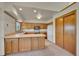 Well-lit kitchen featuring wooden cabinets, a center island, and modern appliances at 2882 Gentry Ct, Watkins, CO 80137