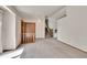 Inviting living area featuring neutral carpet, wood accents, and staircase access to the upper level at 2882 Gentry Ct, Watkins, CO 80137