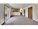 Bright living room with sliding glass doors and staircase, offering access to the kitchen at 2882 Gentry Ct, Watkins, CO 80137