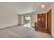 Bright living room with plush carpeting, sliding door access to a deck, and a classic chandelier at 2882 Gentry Ct, Watkins, CO 80137