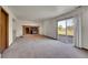 Spacious living room featuring a cozy brick fireplace and sliding glass doors to the outdoors at 2882 Gentry Ct, Watkins, CO 80137
