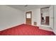 Spare room with an exterior door and red carpet at 2882 Gentry Ct, Watkins, CO 80137