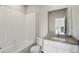 Neutral bathroom featuring tile surround and white vanity with grey countertop at 2992 Oxley St, Strasburg, CO 80136