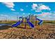 Community playground with slides and playground equipment at 2992 Oxley St, Strasburg, CO 80136