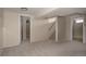 Large finished basement with neutral carpet and walls, and access to the stairwell at 916 Florence St, Aurora, CO 80010