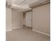 Finished basement with neutral carpet and walls, including access to another room at 916 Florence St, Aurora, CO 80010