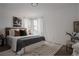 Bright bedroom featuring a well-made bed, neutral color palette, and window at 916 Florence St, Aurora, CO 80010
