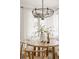 Elegant dining area showcases a wooden table, modern chandelier, and natural light at 916 Florence St, Aurora, CO 80010