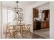 Bright dining area features wood table and chairs, modern lighting, and view into the kitchen at 916 Florence St, Aurora, CO 80010