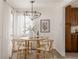 Light dining room features a round wood table with decorative centerpiece and modern lighting at 916 Florence St, Aurora, CO 80010