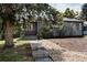 Charming home exterior features stone accents, mature trees, and a landscaped front yard at 916 Florence St, Aurora, CO 80010