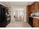 Charming kitchen featuring white tile flooring and black appliances at 916 Florence St, Aurora, CO 80010