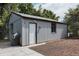 View of the exterior of a storage shed with a grill and room for lawncare equipment at 916 Florence St, Aurora, CO 80010