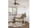 Bright studio features an adjustable drawing desk, a stool, natural light, and a ceiling fan at 916 Florence St, Aurora, CO 80010