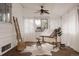 Bright studio features an adjustable drawing desk, a stool, natural light, and a ceiling fan at 916 Florence St, Aurora, CO 80010