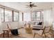 Cozy sunroom featuring ample windows, a neutral sofa, and comfortable seating with a ceiling fan for added comfort at 916 Florence St, Aurora, CO 80010