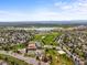 Community aerial view featuring a school, lake, and well-maintained landscaping at 3881 S Bahama St, Aurora, CO 80013