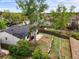 Backyard aerial view with a stone-lined garden, patio, and mature trees at 3881 S Bahama St, Aurora, CO 80013