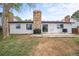 Home backyard with patio, mature trees, and grass at 3881 S Bahama St, Aurora, CO 80013