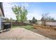 A cozy backyard featuring a concrete patio, a barbecue grill, and a stone fire pit at 3881 S Bahama St, Aurora, CO 80013