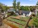 Aerial view of backyard with a stone-lined garden, patio, and mature trees at 3881 S Bahama St, Aurora, CO 80013