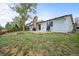 A quaint backyard with a brick chimney, stone patio, and a lush green lawn at 3881 S Bahama St, Aurora, CO 80013
